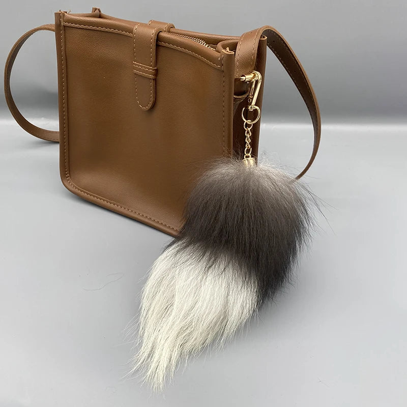 A playful fur tail bag charm for handbags, backpacks, keys, luggage, and everyday styling.