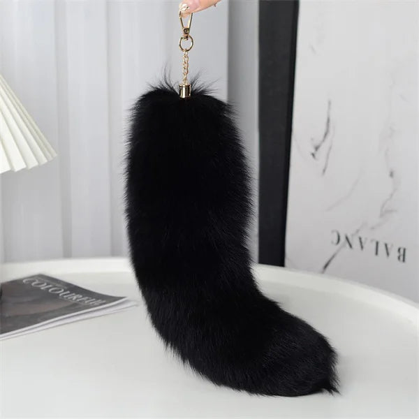 A playful fur tail bag charm for handbags, backpacks, keys, luggage, and everyday styling.