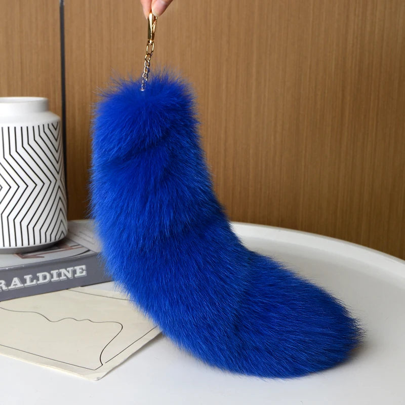 A playful fur tail bag charm for handbags, backpacks, keys, luggage, and everyday styling.
