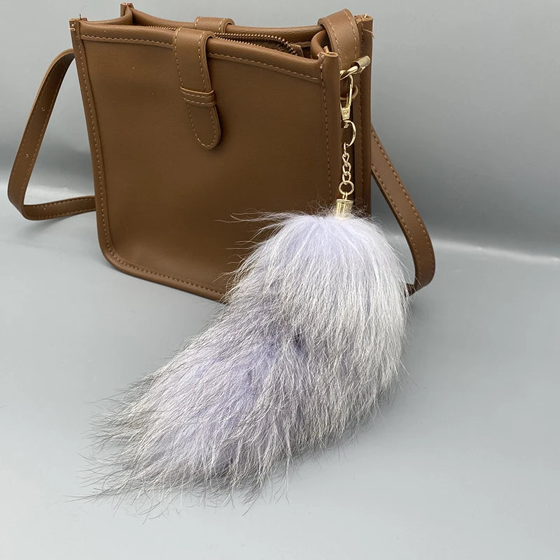 A playful fur tail bag charm for handbags, backpacks, keys, luggage, and everyday styling.