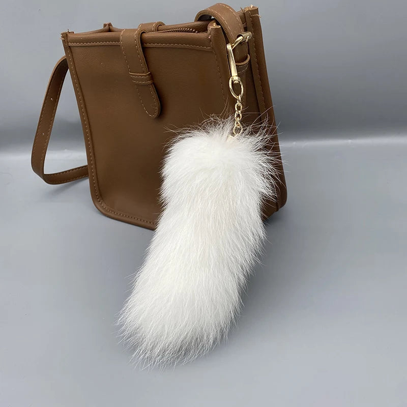 A playful fur tail bag charm for handbags, backpacks, keys, luggage, and everyday styling.