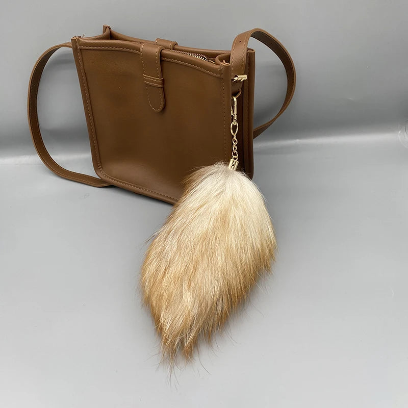 A playful fur tail bag charm for handbags, backpacks, keys, luggage, and everyday styling.