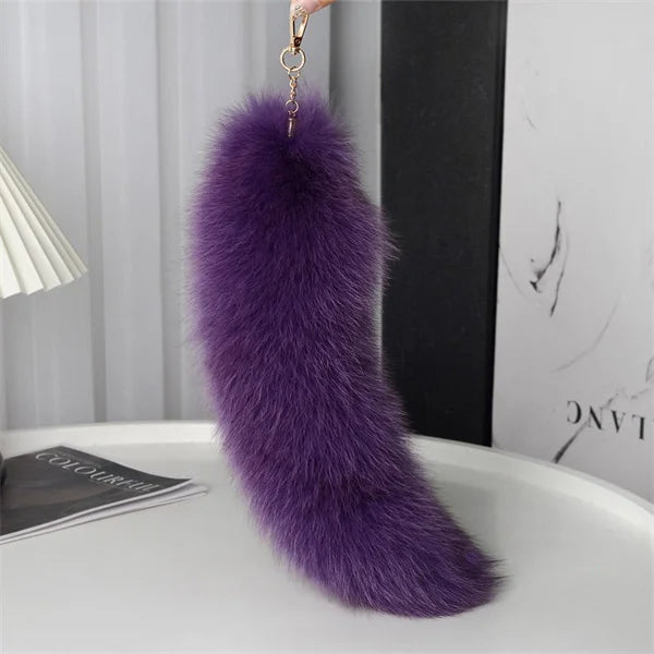A playful fur tail bag charm for handbags, backpacks, keys, luggage, and everyday styling.