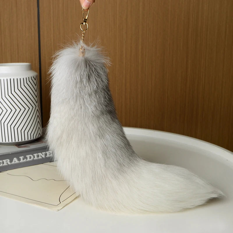 A playful fur tail bag charm for handbags, backpacks, keys, luggage, and everyday styling.