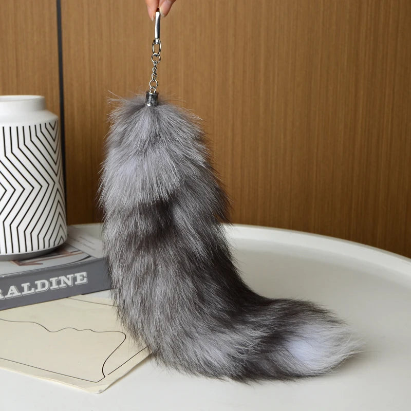 A playful fur tail bag charm for handbags, backpacks, keys, luggage, and everyday styling.