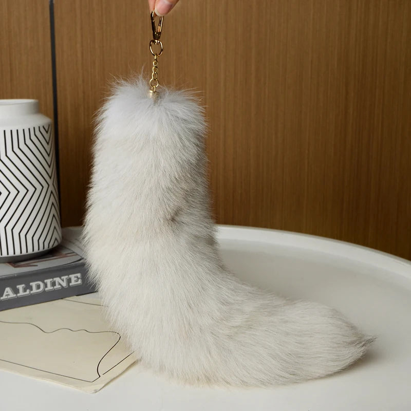 A playful fur tail bag charm for handbags, backpacks, keys, luggage, and everyday styling.