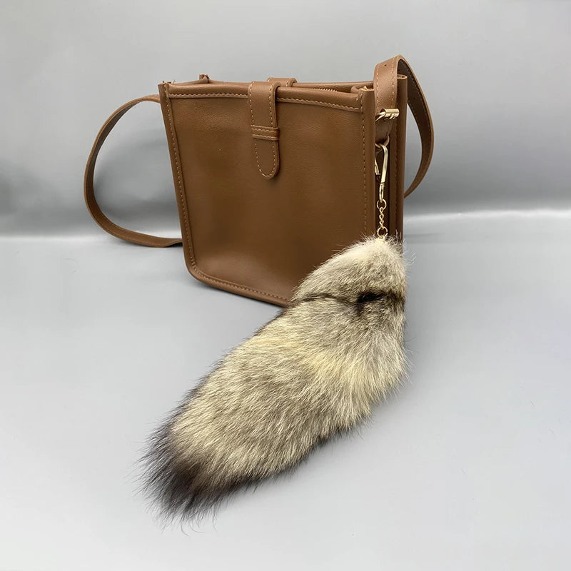 A playful fur tail bag charm for handbags, backpacks, keys, luggage, and everyday styling.