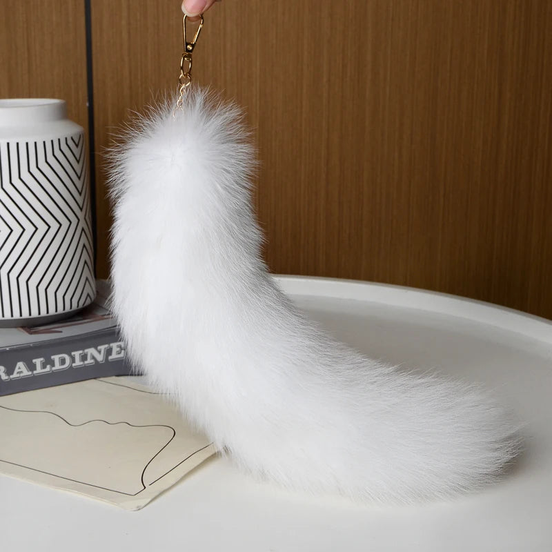A playful fur tail bag charm for handbags, backpacks, keys, luggage, and everyday styling.