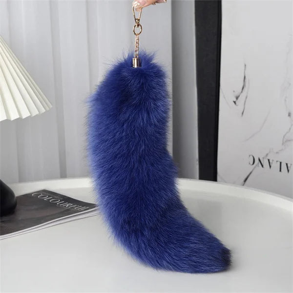 A playful fur tail bag charm for handbags, backpacks, keys, luggage, and everyday styling.