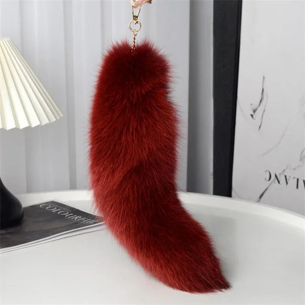 A playful fur tail bag charm for handbags, backpacks, keys, luggage, and everyday styling.