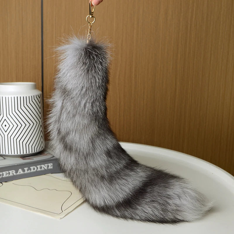 A playful fur tail bag charm for handbags, backpacks, keys, luggage, and everyday styling.
