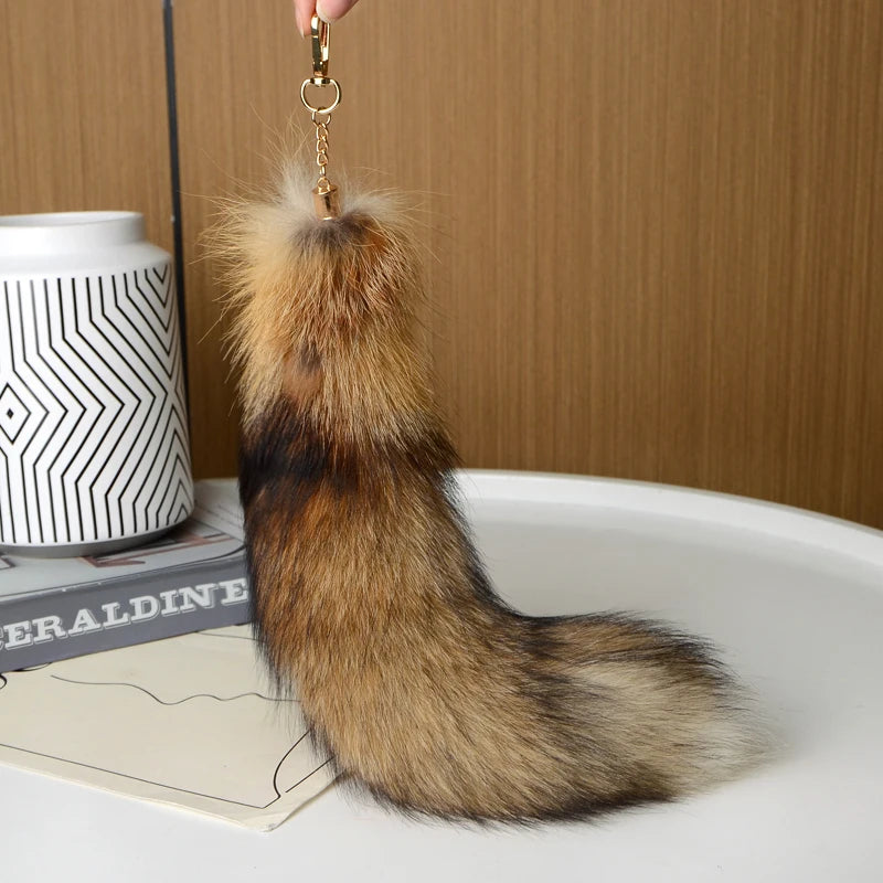 A playful fur tail bag charm for handbags, backpacks, keys, luggage, and everyday styling.
