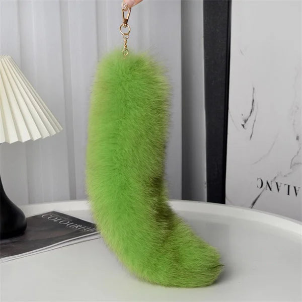 A playful fur tail bag charm for handbags, backpacks, keys, luggage, and everyday styling.