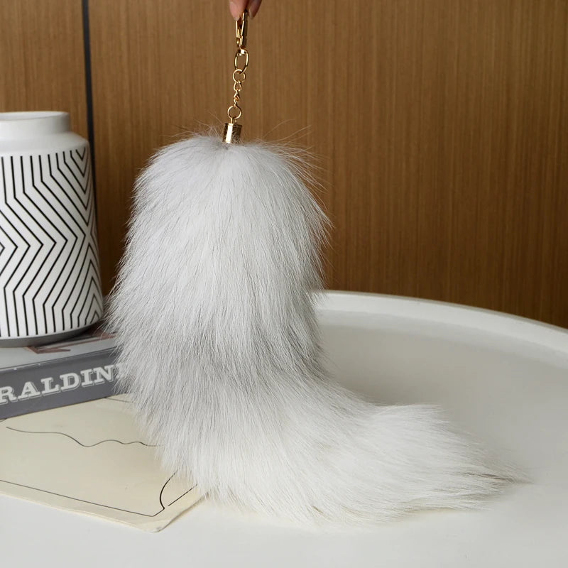 A playful fur tail bag charm for handbags, backpacks, keys, luggage, and everyday styling.
