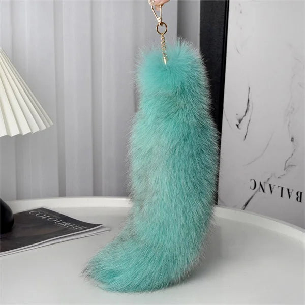 A playful fur tail bag charm for handbags, backpacks, keys, luggage, and everyday styling.