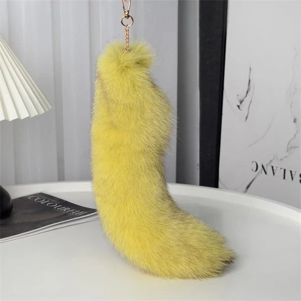 A playful fur tail bag charm for handbags, backpacks, keys, luggage, and everyday styling.