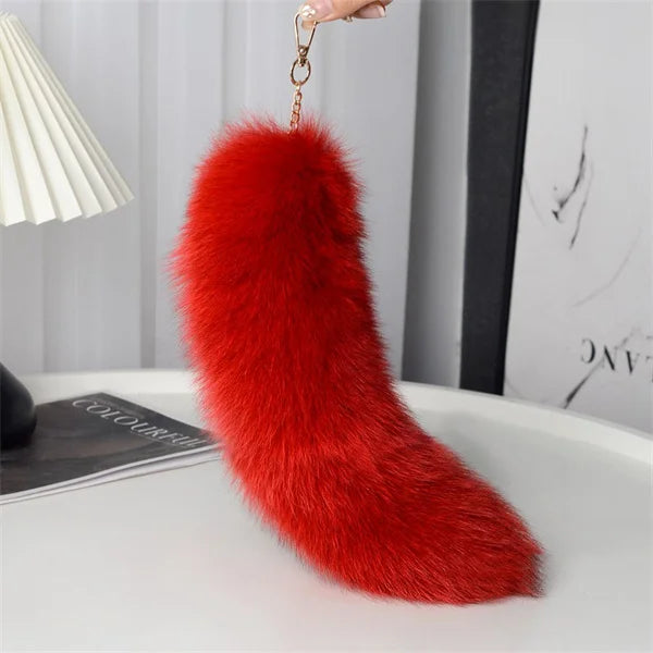 A playful fur tail bag charm for handbags, backpacks, keys, luggage, and everyday styling.