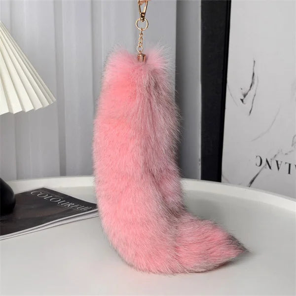 A playful fur tail bag charm for handbags, backpacks, keys, luggage, and everyday styling.