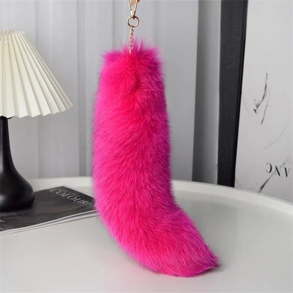 A playful fur tail bag charm for handbags, backpacks, keys, luggage, and everyday styling.
