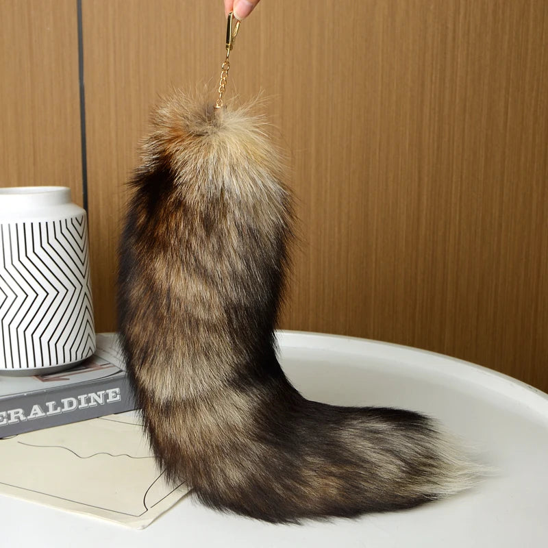 A playful fur tail bag charm for handbags, backpacks, keys, luggage, and everyday styling.
