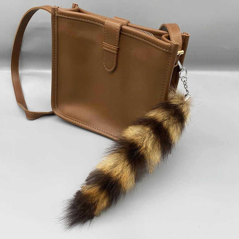 A playful fur tail bag charm for handbags, backpacks, keys, luggage, and everyday styling.